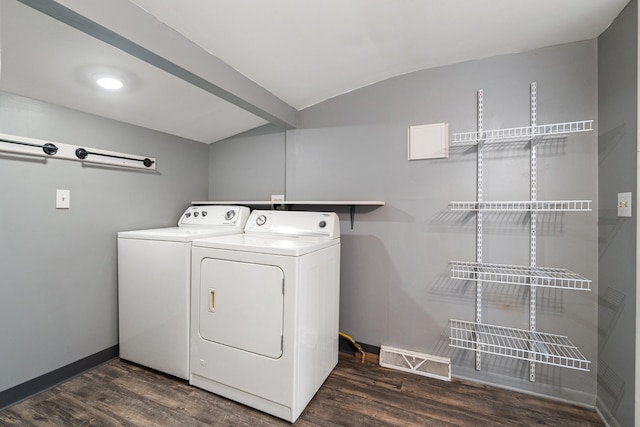 laundry area featuring washing machine and dryer, laundry area, baseboards, and dark wood-style flooring