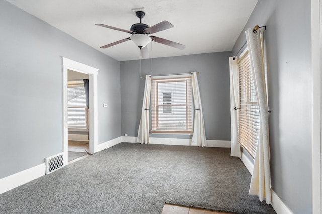 unfurnished bedroom with carpet, a ceiling fan, and baseboards