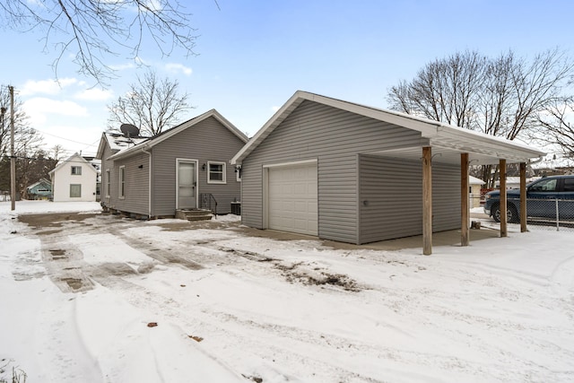 view of front of property with a garage, an outdoor structure, and fence