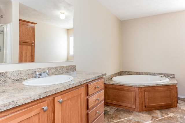 full bathroom featuring a bath, stone finish flooring, and vanity