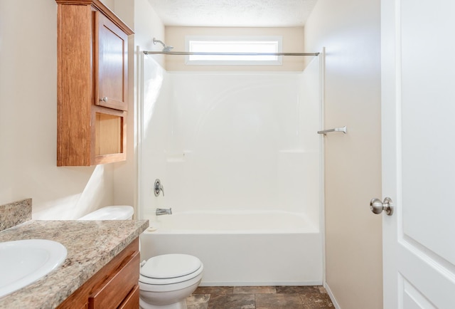 bathroom featuring shower / bathtub combination, toilet, vanity, a textured ceiling, and baseboards