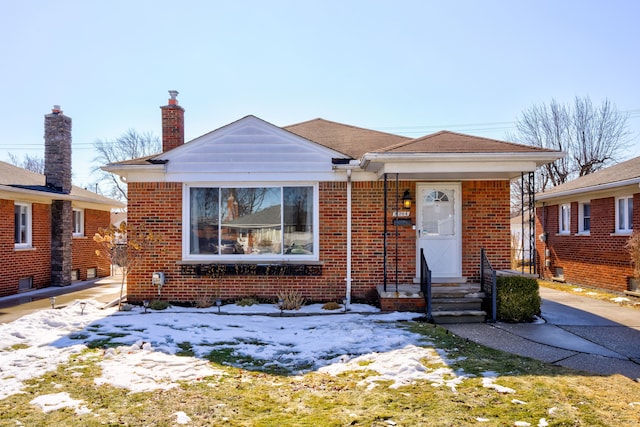 bungalow-style house with brick siding