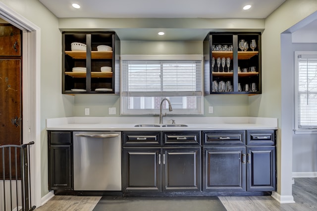 kitchen with dishwasher, open shelves, a sink, and light countertops