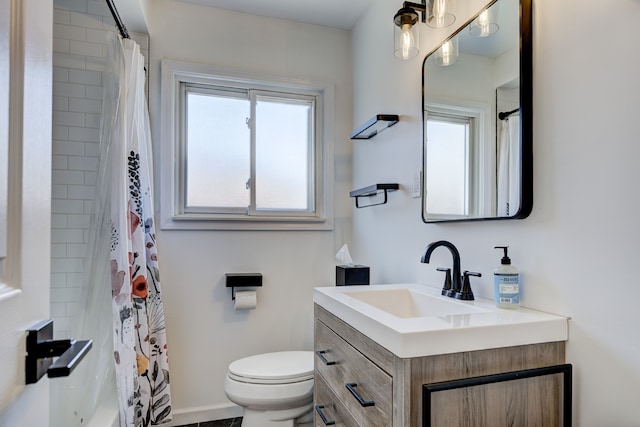 bathroom with toilet, a shower with shower curtain, and vanity