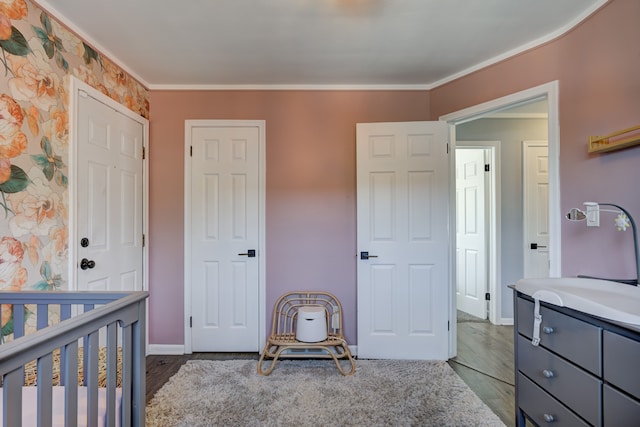 bedroom featuring ornamental molding, a sink, and baseboards