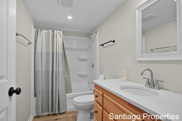 full bath featuring vanity, shower / bath combo, wood finished floors, and visible vents