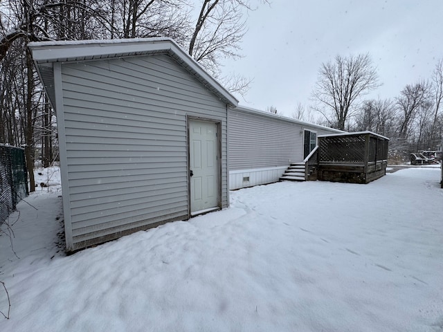 snow covered house featuring crawl space and a wooden deck