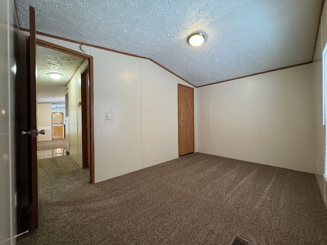 interior space featuring crown molding, vaulted ceiling, and a textured ceiling