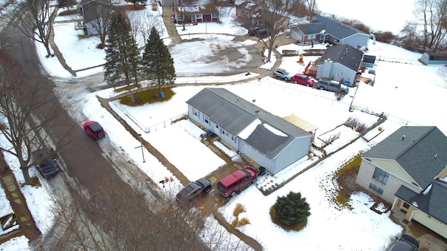 snowy aerial view with a residential view