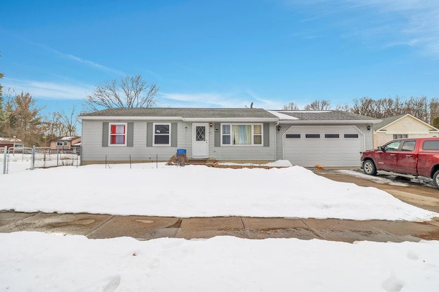 ranch-style house with a garage and fence