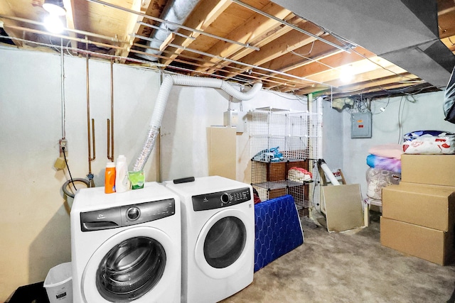 laundry area featuring laundry area, electric panel, and washer and clothes dryer