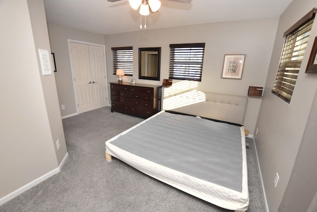 bedroom featuring carpet, a closet, ceiling fan, and baseboards