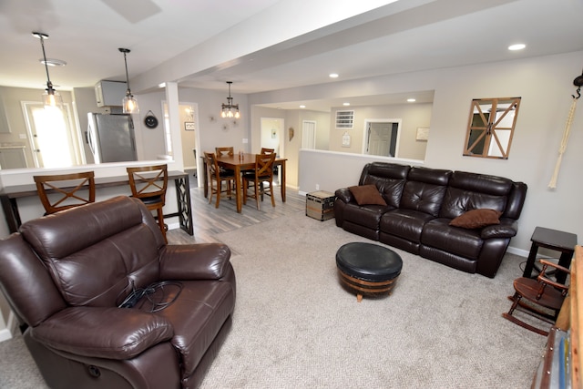 living area featuring recessed lighting and baseboards