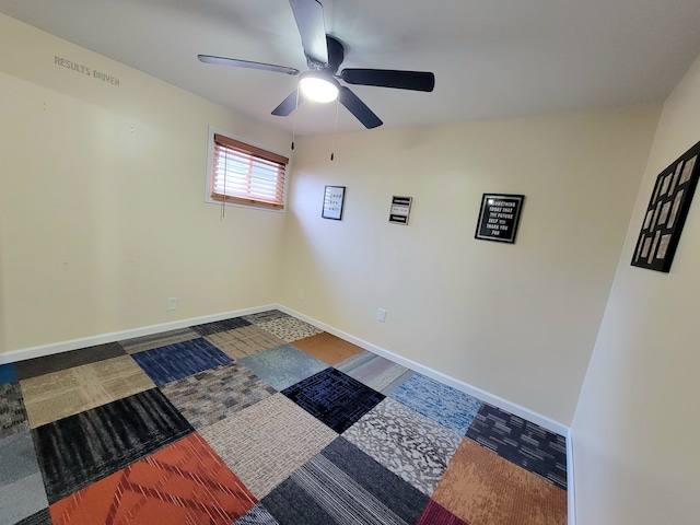 empty room with baseboards and ceiling fan