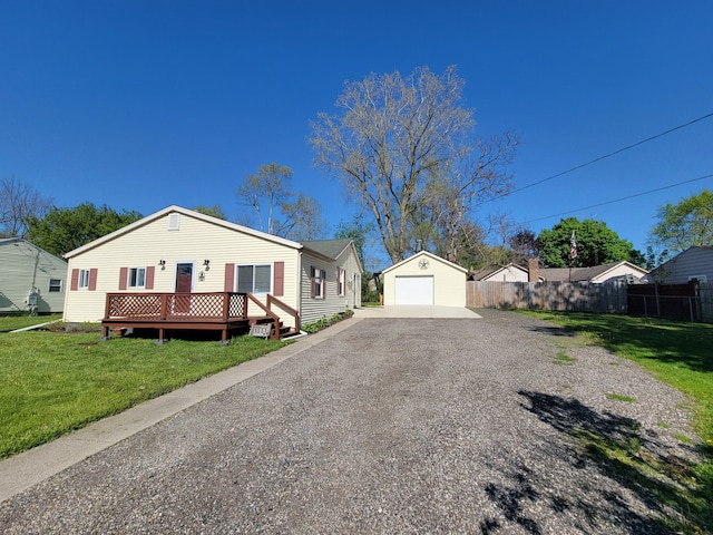 view of front of house featuring an outdoor structure, a garage, driveway, and a wooden deck