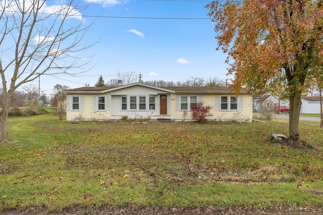 ranch-style home with a front lawn