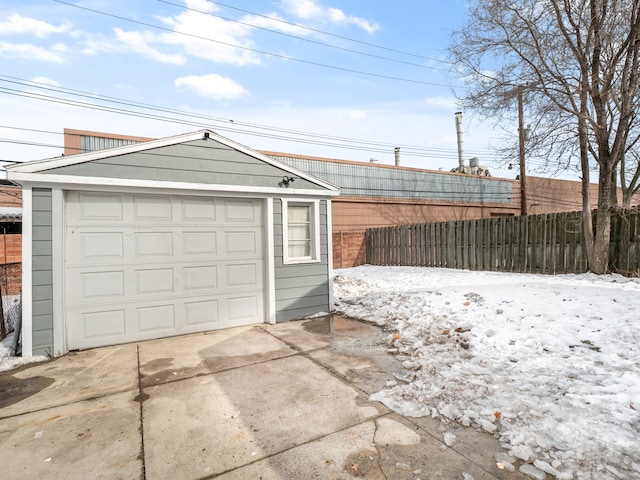 detached garage with driveway and fence