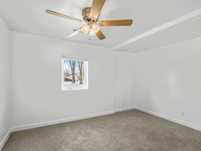 carpeted empty room featuring ceiling fan and baseboards