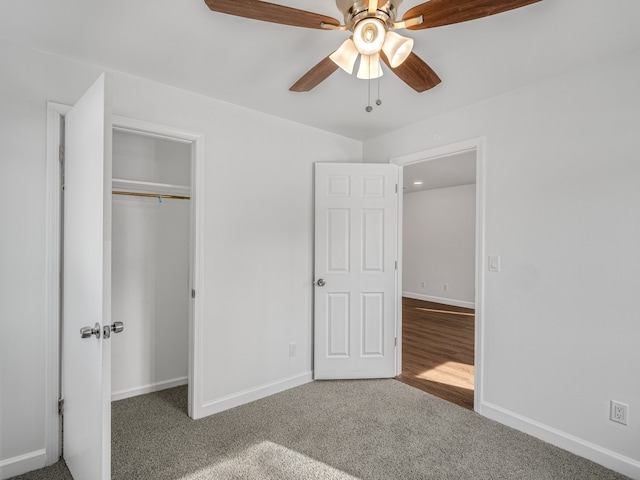 unfurnished bedroom with a ceiling fan, carpet, baseboards, and a closet