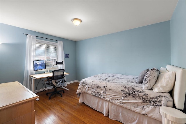 bedroom with baseboards and hardwood / wood-style floors