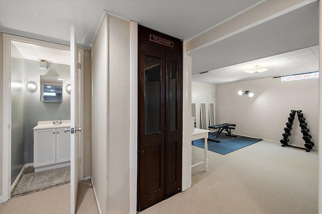 hall with carpet flooring and a sink