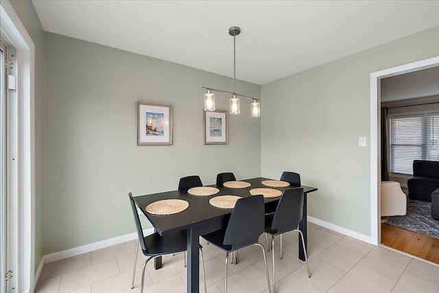 dining area featuring light tile patterned floors and baseboards