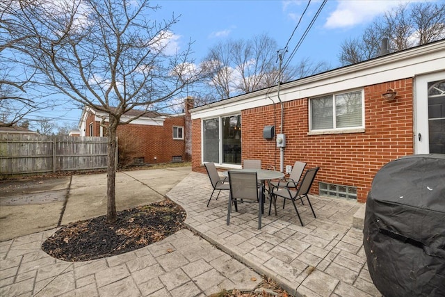 view of patio with area for grilling and fence