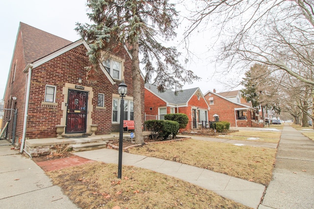 view of front of house with brick siding and fence