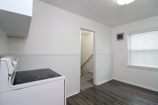 kitchen featuring a wainscoted wall, electric range, and dark wood-type flooring