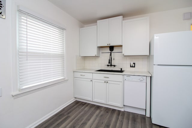 kitchen with white appliances, a sink, white cabinetry, light countertops, and backsplash