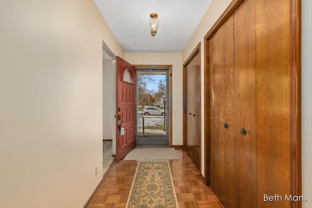 doorway to outside featuring baseboards