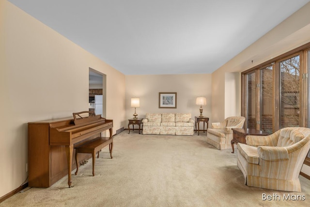 living room featuring carpet and baseboards