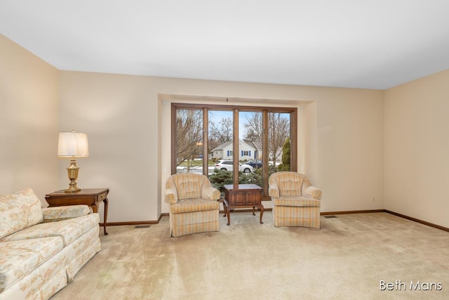 living area featuring carpet and baseboards