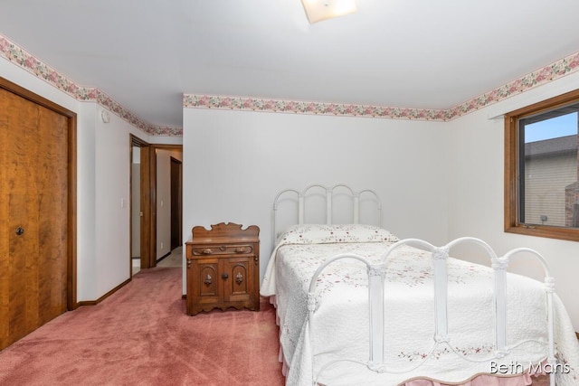 bedroom featuring carpet, a closet, and baseboards