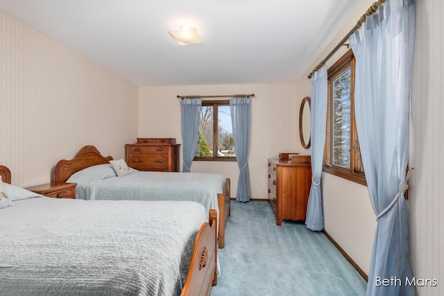 bedroom with light carpet and baseboards