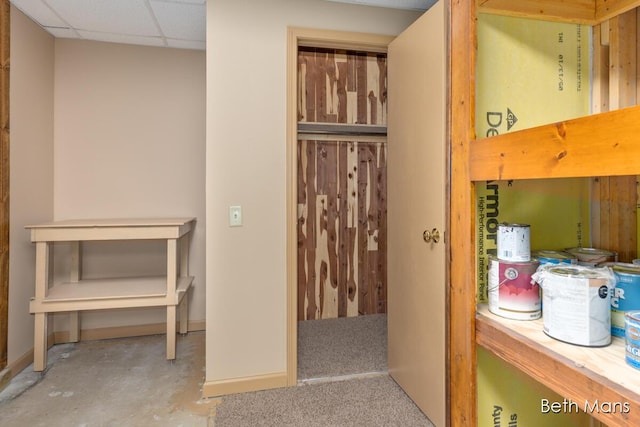 bathroom with a drop ceiling and baseboards