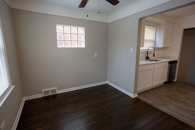 unfurnished dining area featuring baseboards, visible vents, a ceiling fan, dark wood-style flooring, and a sink