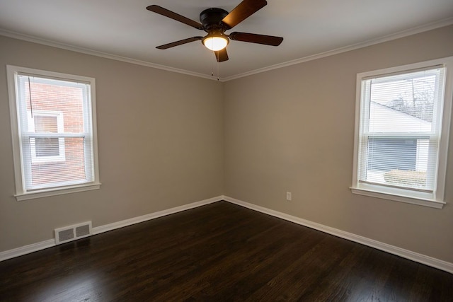 unfurnished room with baseboards, visible vents, a ceiling fan, dark wood-style floors, and crown molding