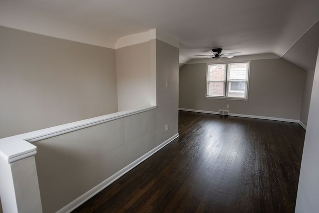 bonus room featuring lofted ceiling, visible vents, a ceiling fan, wood finished floors, and baseboards