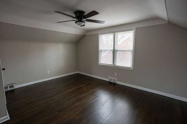 bonus room featuring dark wood-type flooring, visible vents, and baseboards