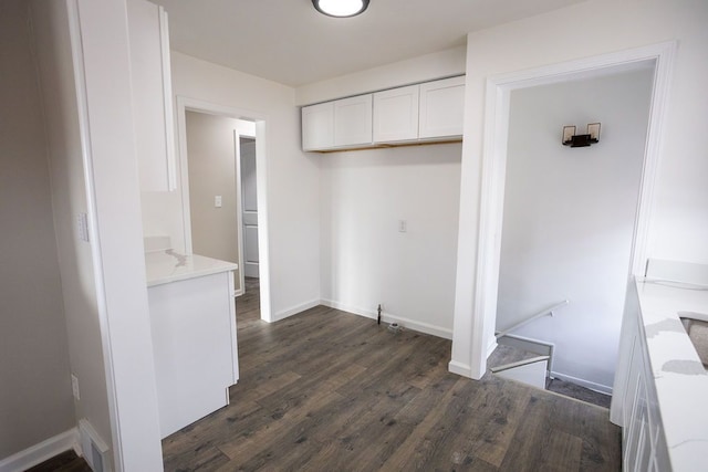 interior space with visible vents, baseboards, and dark wood-style flooring