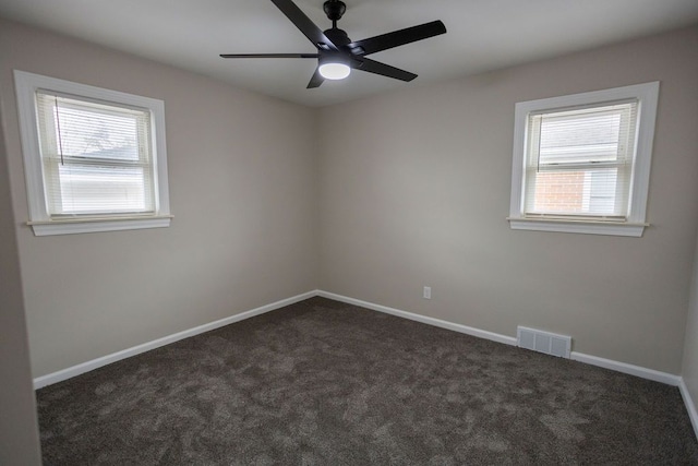 spare room with carpet, visible vents, plenty of natural light, and baseboards