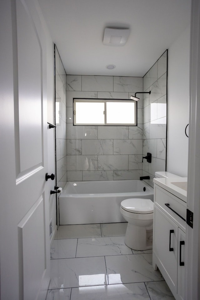 bathroom with marble finish floor, toilet, vanity, and shower / tub combination