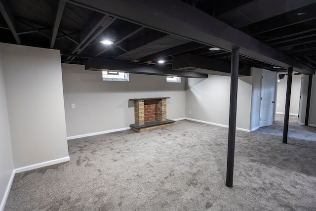 below grade area featuring carpet flooring and baseboards