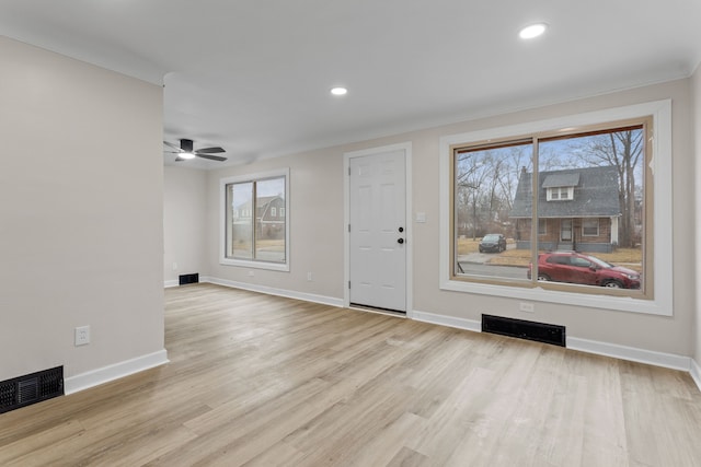 entryway featuring visible vents, baseboards, and wood finished floors