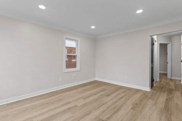 empty room featuring light wood-style floors, baseboards, and recessed lighting