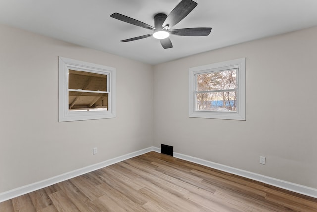 unfurnished room with light wood-style flooring, baseboards, and a ceiling fan