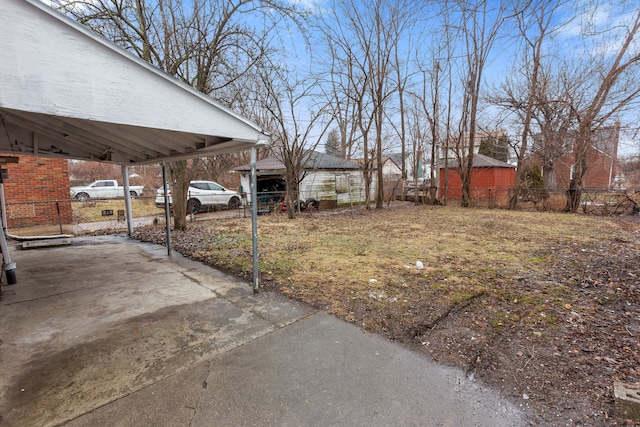 view of yard with a carport and fence