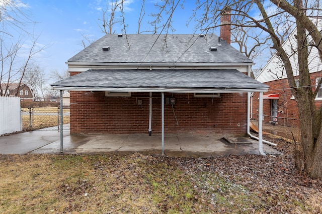 back of property with a patio area, fence, and brick siding