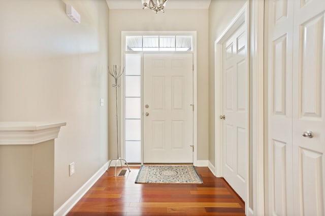 foyer with baseboards and wood finished floors